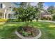 Lush green lawn showcases a lovely crape myrtle tree surrounded by colorful flower beds at 321 Wescott Ridge Dr, Holly Springs, NC 27540