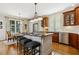 Eat-in kitchen featuring a kitchen island with granite countertops and stainless steel appliances at 321 Wescott Ridge Dr, Holly Springs, NC 27540