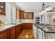 Charming kitchen with stainless appliances, wood cabinets, and a sleek countertop at 321 Wescott Ridge Dr, Holly Springs, NC 27540