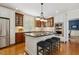 Lovely kitchen with a granite island, stainless appliances, and dark wood accents at 321 Wescott Ridge Dr, Holly Springs, NC 27540