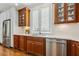 Bright kitchen with stainless steel appliances, wooden cabinets, and marble countertops at 321 Wescott Ridge Dr, Holly Springs, NC 27540