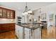 Open kitchen with island cooktop, granite counters and an open concept view to the living room at 321 Wescott Ridge Dr, Holly Springs, NC 27540