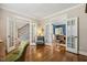 Living area with hardwood flooring, neutral paint, with view into adjacent dining room and stairs at 321 Wescott Ridge Dr, Holly Springs, NC 27540