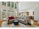 Bright and airy living room with large windows, hardwood floors, and a view of the kitchen at 321 Wescott Ridge Dr, Holly Springs, NC 27540