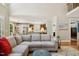 Spacious living room with hardwood floors leading to a white kitchen with stainless appliances at 321 Wescott Ridge Dr, Holly Springs, NC 27540