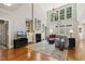 Bright living room features a fireplace, built-in shelving, a large chandelier, and tall windows at 321 Wescott Ridge Dr, Holly Springs, NC 27540