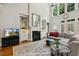 Bright living room features a fireplace, built-in shelving, a large chandelier, tall windows, and a patterned rug at 321 Wescott Ridge Dr, Holly Springs, NC 27540