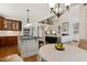 Spacious open-concept living room and kitchen area with high ceilings and a fireplace at 321 Wescott Ridge Dr, Holly Springs, NC 27540