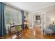 Sunlit office featuring hardwood floors, shutters, and view into adjacent entry with stairs at 321 Wescott Ridge Dr, Holly Springs, NC 27540