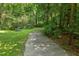 Scenic paved path winding through a forest, providing a peaceful escape and walking opportunity at 321 Wescott Ridge Dr, Holly Springs, NC 27540