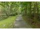 Tree-lined path creating a tranquil walking experience for residents to enjoy at 321 Wescott Ridge Dr, Holly Springs, NC 27540