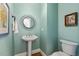 Stylish powder room with pedestal sink and decorative mirror at 321 Wescott Ridge Dr, Holly Springs, NC 27540