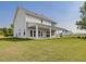 Expansive backyard with a covered patio featuring classic white pillars at 323 Flourishing Street, Sanford, NC 27330