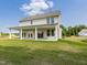 View of the backyard and covered patio with white pillars, great for outdoor enjoyment at 323 Flourishing Street, Sanford, NC 27330