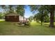 Large backyard with steps down to a spacious, shady area perfect for entertaining or relaxation at 516 Ivey Rd, Graham, NC 27253