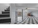 Large basement with checkered flooring and stairs leading upwards at 516 Ivey Rd, Graham, NC 27253