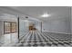 Spacious basement featuring checkered flooring and doorway to outside at 516 Ivey Rd, Graham, NC 27253