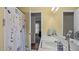 Bright bathroom with a floral shower curtain, tile floors, and a white countertop at 516 Ivey Rd, Graham, NC 27253