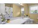 Bright bathroom featuring a bathtub with shower and vanity with sink at 516 Ivey Rd, Graham, NC 27253