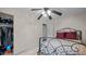 Bedroom showcasing a bed, closet with shelving, and a ceiling fan at 516 Ivey Rd, Graham, NC 27253