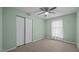 Neutral bedroom with light green walls, a ceiling fan, and a closet at 516 Ivey Rd, Graham, NC 27253