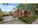 Charming brick home with well-manicured landscaping and an outdoor patio at 516 Ivey Rd, Graham, NC 27253