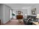 Bright living room with large windows, plush seating, and a classic piano for added charm at 516 Ivey Rd, Graham, NC 27253
