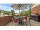 Outdoor patio area with a table, seating, and an umbrella for shade at 516 Ivey Rd, Graham, NC 27253