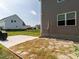 View of the backyard featuring a concrete patio, lawn, and privacy fence at 5215 Goshawk Ln, Graham, NC 27253