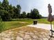 Spacious backyard featuring a lush lawn, fence, and a patio area with a grill and umbrella at 5215 Goshawk Ln, Graham, NC 27253