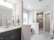 Bathroom with a double sink vanity, shower, and linen closet at 5215 Goshawk Ln, Graham, NC 27253