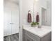 Bathroom featuring a gray vanity, white quartz countertop, modern faucet and mirror at 5215 Goshawk Ln, Graham, NC 27253