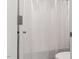 Bright bathroom featuring a white shower curtain and partial view of the toilet at 5215 Goshawk Ln, Graham, NC 27253