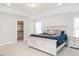 Bright bedroom with a tray ceiling, light hardwood floors, and a spacious closet at 5215 Goshawk Ln, Graham, NC 27253