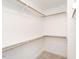 Walk-in closet with shelves and hanging rods at 5215 Goshawk Ln, Graham, NC 27253