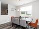 Bright dining room features a modern chandelier, large window, and wood-look flooring at 5215 Goshawk Ln, Graham, NC 27253