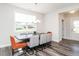 Bright dining area with modern chandelier, grey wood floors, and large window at 5215 Goshawk Ln, Graham, NC 27253