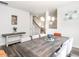 Dining room with modern lighting, stylish décor, and grey wood-look flooring at 5215 Goshawk Ln, Graham, NC 27253