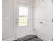 Bright entryway features a glass panel door, closet, and stylish gray wood-look floors at 5215 Goshawk Ln, Graham, NC 27253