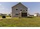 Rear exterior view of the home showcasing the back patio and fenced yard at 5215 Goshawk Ln, Graham, NC 27253
