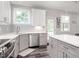 Well-lit kitchen featuring stainless steel appliances and views of the backyard at 5215 Goshawk Ln, Graham, NC 27253