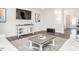 Spacious living area featuring gray floors, a large TV, and ample natural light at 5215 Goshawk Ln, Graham, NC 27253