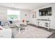 Cozy living room with neutral-toned furniture, a large area rug, and a big screen tv at 5215 Goshawk Ln, Graham, NC 27253