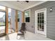 Relax on the screened-in porch with views of a well-maintained lawn and nearby houses at 5215 Goshawk Ln, Graham, NC 27253