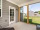 Inviting screened-in porch provides relaxing views of the lush, green backyard at 5215 Goshawk Ln, Graham, NC 27253