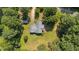 Birds eye view shows the roof and layout of the home, showcasing the surrounding lush green lawn and mature trees at 545 Barnette Rd, Louisburg, NC 27549