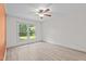 Bright bedroom with ceiling fan, hard surface floors, and window looking out to a lush yard at 545 Barnette Rd, Louisburg, NC 27549