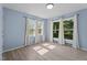 A serene bedroom with natural light, neutral walls, and wood-look flooring at 545 Barnette Rd, Louisburg, NC 27549