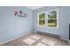 Bright bedroom with hardwood floors, a window, and light blue walls at 545 Barnette Rd, Louisburg, NC 27549