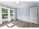 A well lit bedroom features large windows and light blue walls at 545 Barnette Rd, Louisburg, NC 27549